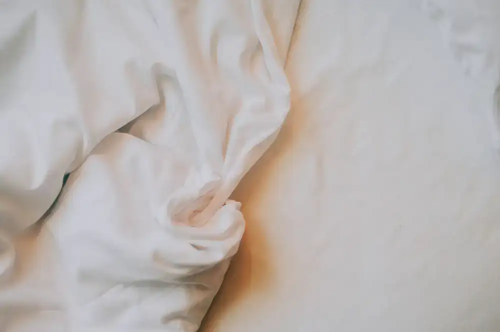 Folded fresh white bed sheets and towels